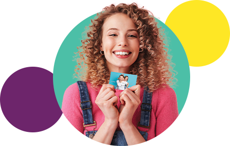 Smiling girl holding gift card in hand